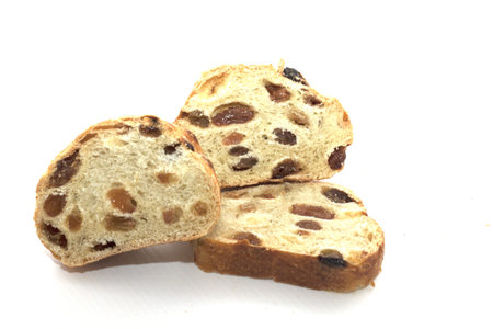 round bread with dried raisins isolated on white