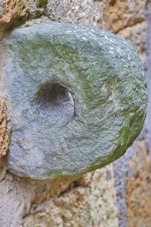 stone artifact with hole attached to the wall ancient useの写真素材