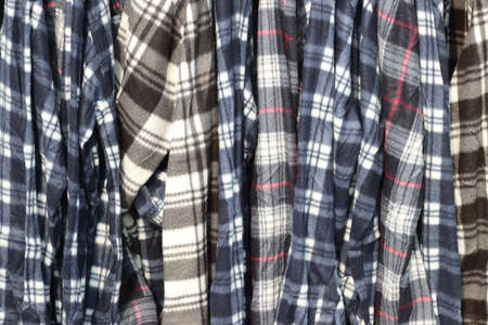 mixed clothing of various colors and sizes hanging and exposedの写真素材