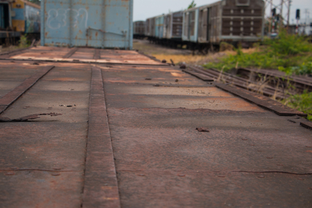 Old trains are parked outdoors where they are exposed to the heat of sunlight and rain, resulting in cracking and rusting.の写真素材