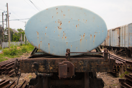 Old trains are parked outdoors where they are exposed to the heat of sunlight and rain, resulting in cracking and rusting.の写真素材