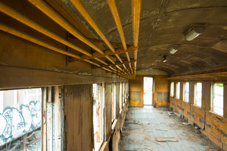 Old trains are parked outdoors where they are exposed to the heat of sunlight and rain, resulting in cracking and rusting.の写真素材
