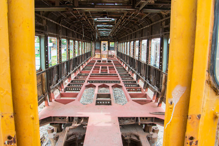 Old trains are parked outdoors where they are exposed to the heat of sunlight and rain, resulting in cracking and rusting.の写真素材