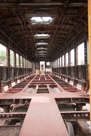 Old trains are parked outdoors where they are exposed to the heat of sunlight and rain, resulting in cracking and rusting.の写真素材