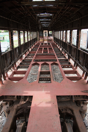 Old trains are parked outdoors where they are exposed to the heat of sunlight and rain, resulting in cracking and rusting.の写真素材