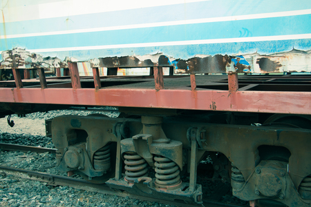 Old trains are parked outdoors where they are exposed to the heat of sunlight and rain, resulting in cracking and rusting.の写真素材