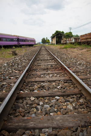 Old trains are parked outdoors where they are exposed to the heat of sunlight and rain, resulting in cracking and rusting.の写真素材