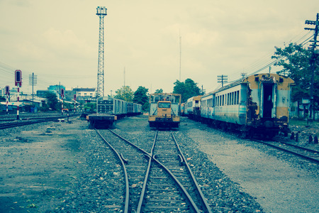 Old trains are parked outdoors where they are exposed to the heat of sunlight and rain, resulting in cracking and rusting.の写真素材