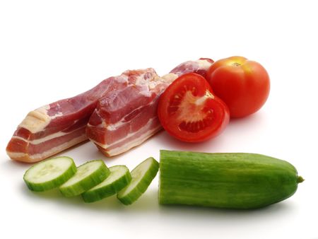 smoked bacon with vegetables isolated on the white backgroundの写真素材