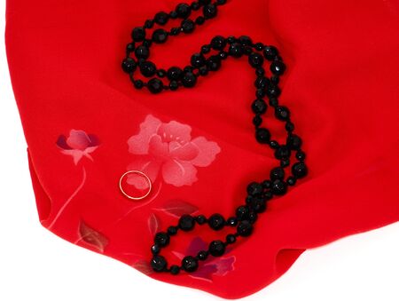 golden ring at the red scarf isolated on white backgroundの写真素材