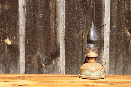 Rustic old oil lamp on a wooden backgroundの写真素材