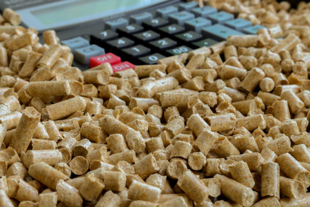 Wood pellets and calculator - the Concept of saving. .Biofuels, An alternative fuel for the boiler. Wood pellets used as cat litter.の写真素材