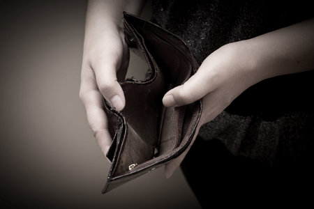 Old empty wallet in the hands of women. Poverty concept.