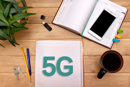 Notes 5G in the Notepad on the Desk of a businessman.の写真素材