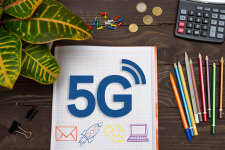 Notebook with a notes 5G on the office table with tools. Concept with elements of infographics.の写真素材