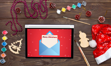 Merry Christmas, received an email on the tablet. Christmas background template.
