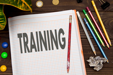 Notebook with a notes TRAINING on the office table with tools. Business conceptの写真素材