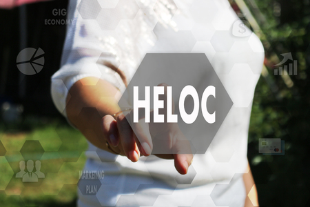 The businessman chooses the HELOC, Home Equity Line of Credit on a touch screen. Concept HELOCの写真素材