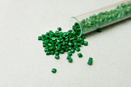 Plastic pallets . Plastic raw materials in granules for industry.Green Polymeric dye on a silver background. Plastic granules after processing of waste polyethylene and polypropylene.Polymer.の写真素材