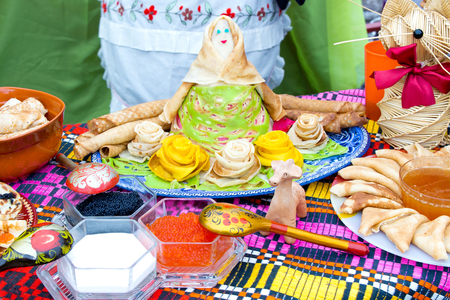 Shrovetide, pancake week, festival meal. Pancakes with caviar, honey, jam, curd, berries . Rustic style. Doll women of pancakes.の写真素材