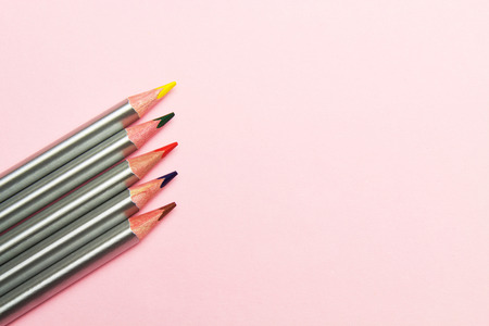 Colored pencils on pastel pink background. Trend colors, Pattern.Multi-colored wooden pencils with silvery coatingの写真素材