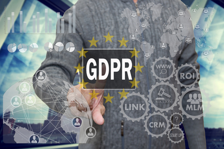 An elderly pensioner is studying information GDPR on the touch screen .General Data Protection Regulation concept may 25, 2018.の写真素材