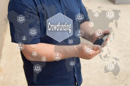 Crowdfunding on the touch screen with a blur background of the businessman with the phone.The concept of Crowdfunding の写真素材