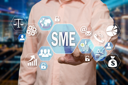 The businessman chooses the Small and Medium Enterprise, SME on the virtual screen in the business network connection.の写真素材