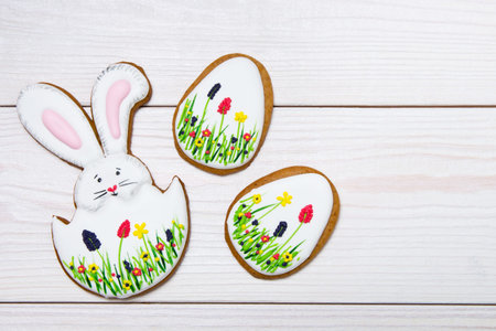 Easter gingerbread set  on white wooden background.  Easter Bunny and eggs, gingerbread
