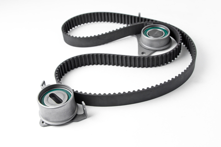 Spare parts for the ca r. Kit of timing belt with rollers on a light background.の写真素材