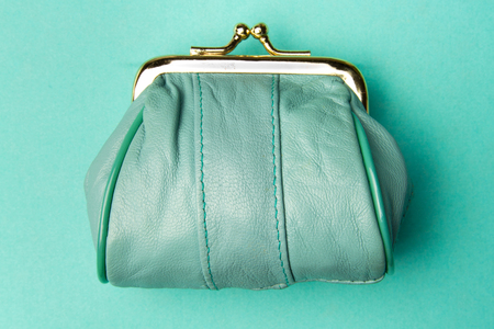 Purse for coins.Wallet for change. A leather purse, wallet on a turquoise background. Trend colors.の写真素材
