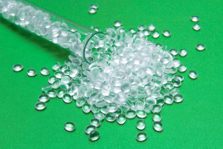 Transparent Polyethylene granules on a green backgroundの写真素材