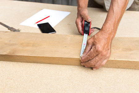 Carpenter inspect the quality of the material and calculate the required quantity for production...