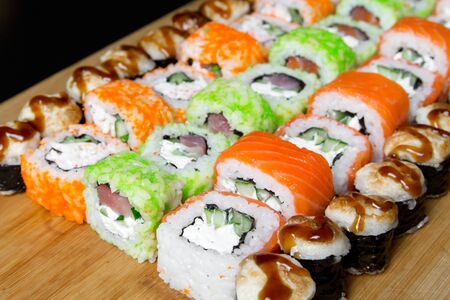 Sushi Philadelphia rolls, California, Miami rolls and bake the classic rolls on Board made of bamboo. Sushi food photo for menu. Combo set of rolls Sushiの写真素材
