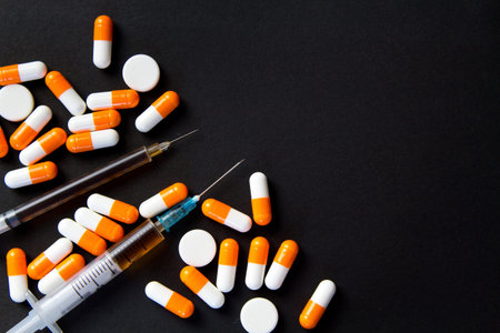 Drug abuse Concept. Syringe and pills preparation and prepared the heroin on the black table. Stop the use of drugs.Opioid epidemic .の写真素材