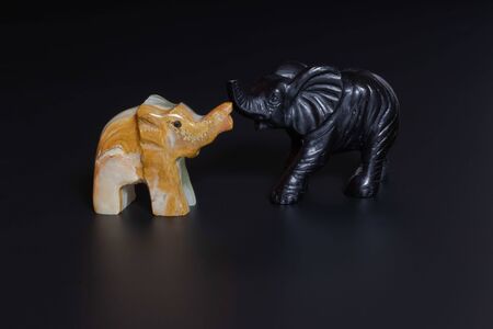 elephant figurines on a black backgroundの写真素材