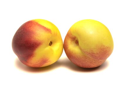 ripe peach lies on a white backgroundの写真素材