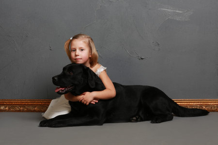 Little girl and dog in the studio (photoshoot)の写真素材