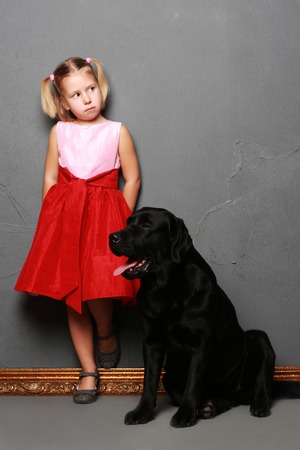 Little girl and dog in the studio (photoshoot)の写真素材