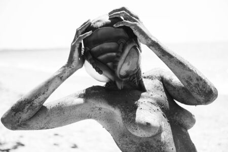 Sexy naked girl on the beach photoshootの写真素材