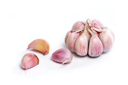 Raw garlic cloves and bulb isolated on white.の写真素材