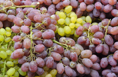 Fresh Red And Green Wine Grapes In Sale At The Market. Fruit Background.