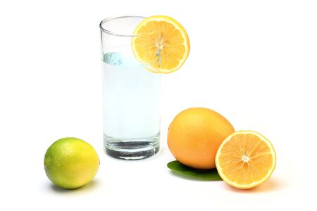 Fresh Water In Glass With Lemon. Fresh Meyer Lemons And Limes Isolated On White Background.の写真素材