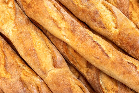 French baguettes in bakery close-up. Selective focus. Fresh bread and baguettes background.の写真素材