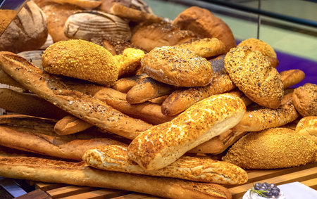 Delicious loaves of bread in baker shop. Different types of bread loaves on bakery shelves.