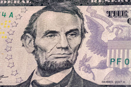 Close-up of 5 us dollar bill. Portrait of President Abraham Lincoln on the five us dollars banknote.の写真素材