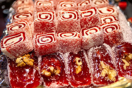 Oriental Sweets. Traditional Turkish Delight (Rahat Lokum) Close-up. Turkish Delight with walnuts and coconut shavings. Selective focus Top view.の写真素材