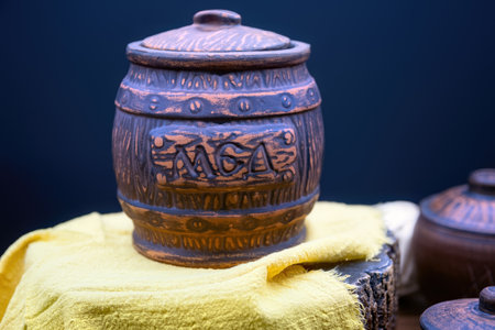 Clay pot for honey isolated on dark blue background.の写真素材