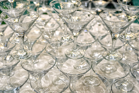 Stack of empty champagne glasses on the table in restaurant. Selective focus.の写真素材