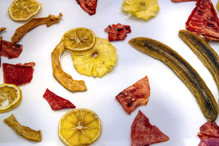 Dry dried sliced ââfruits in the form of chips isolated on white background, top view.の写真素材